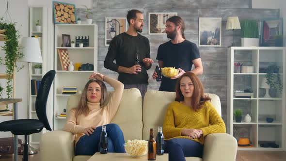 Group of Friends Watching a Football Match in Living Room