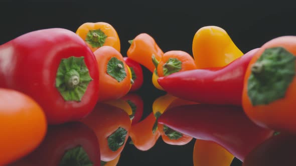 Colorful fresh peppers on mirrored table