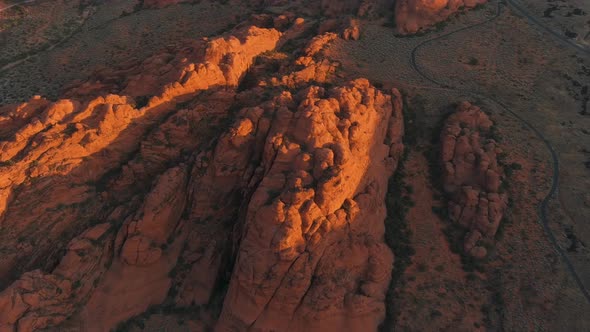 Orbiting aerial of Utah's desert landscape getting hit by the first glow of the morning sun.