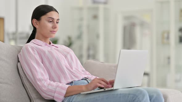 Young Latin Woman Working on Laptop at Home 