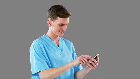 Smiling surgeon using mobile phone