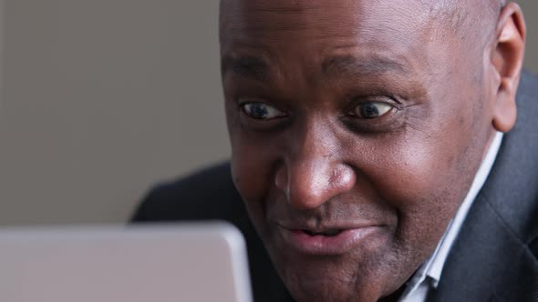 Mature African Business Man Using Laptop for Video Call Speaks Remotely Emotionally