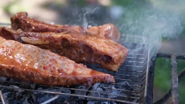 Delicious Beef or Pork Ribs Frying on a Charcoal Grill