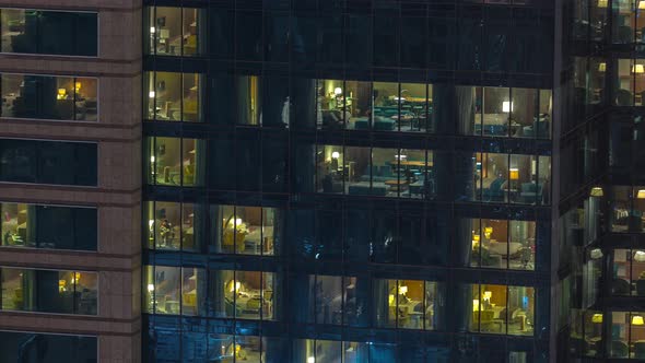 Outside View of Windows in Apartments of a High Class Building at Night Timelapse