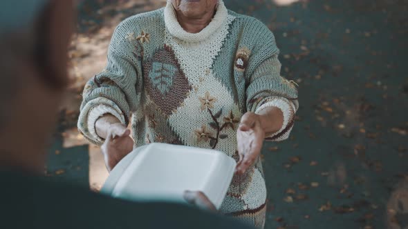 Old Vulnerable Homeless Woman Getting Free Charity Meal