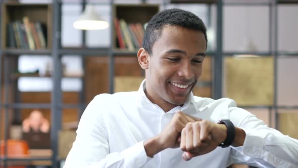Black Man Using Smartwatch in Office