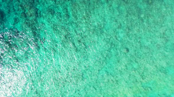 Aerial view sky of tranquil seashore beach break by blue water and white sand background of a dayout