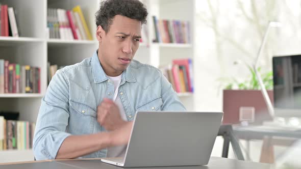 Coughing Young African American Man Working on Laptop 