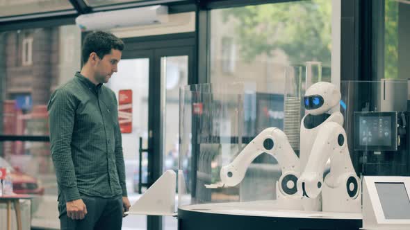 Coffeeserving Robot is Moving Its Arms While Waiting for Clients