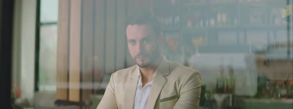 Man in light suit sitting in cafe