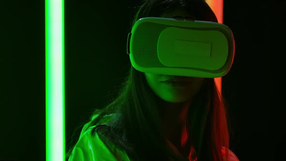 Portrait of a Pretty Young Beautiful Woman with Virtual Reality Goggles. Close Up. Slow Motion.