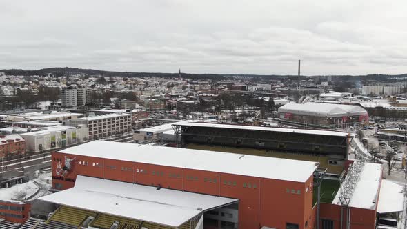 Boras cityscape and stadium in winter season seen from above, aerial drone circling view. Sweden