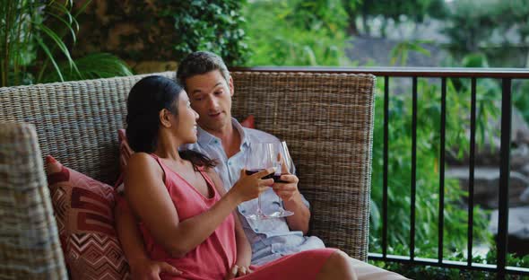 Couple Enjoying Glass of Wine at Luxury Resort