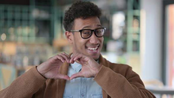 Portrait African Man Making Heart Shape By Hands