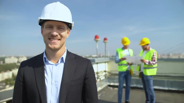 Smiling Construction Engineer in Safety Helmet Looking Camera, Skilled Architect