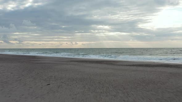 Ocean with Sea Gulls Flying in Northern Europe with Stunning Sunset Cloud Formation, Low Aerial