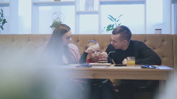 Long Haired Lady Runs Hand on Child Head Playing with Straws