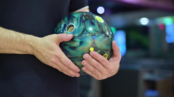 bowling ball in the player's hand. The camera zooms out and shows the player