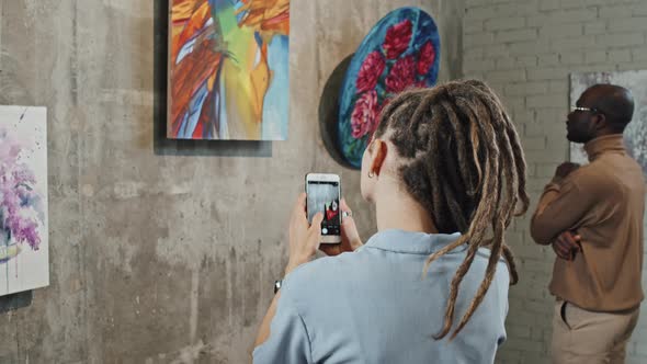 Girl Taking Pictures of Paintings