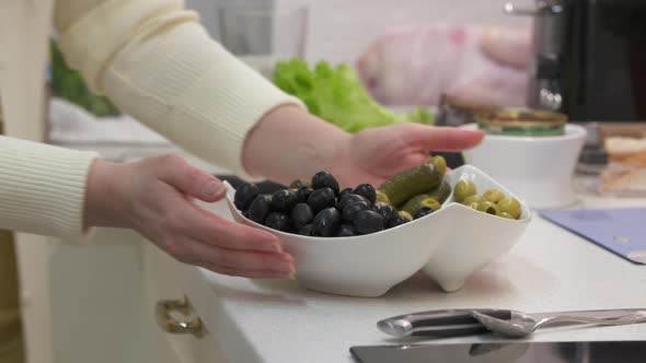 Woman Cooking Festive Dinner Preparing Appetizers in the Kitchen Female Hands Putting Pickles and