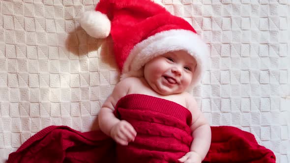 Smiling Baby Wearing Red Santa Claus Hat Celebrating Christmas