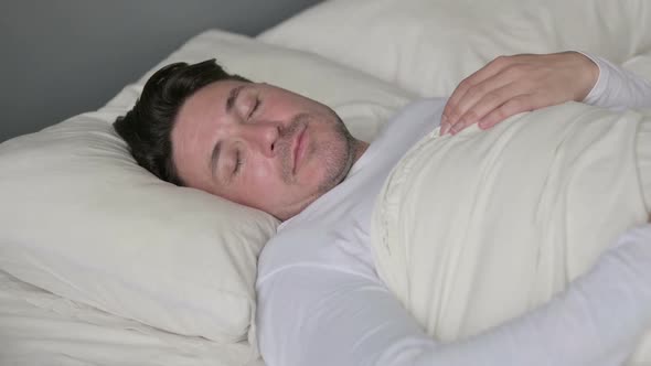 Peaceful Middle Aged Man Sleeping in Bed