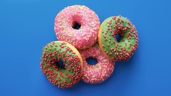 Portion of Ring Donuts Rotating Isolated on Blue Background