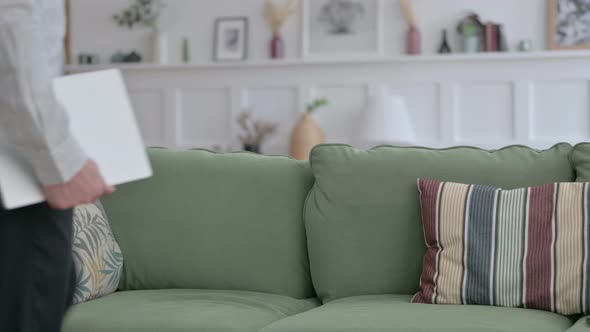 Man Coming Siting on Sofa