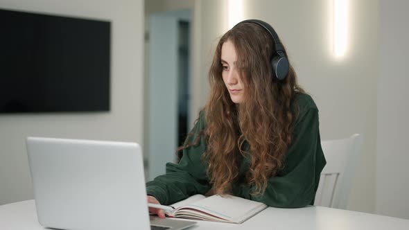 Concertrated Student Girl Has Distant Lesson on Laptop Making Notes