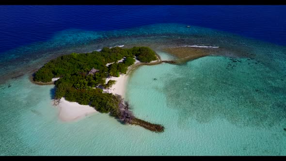 Aerial flying over panorama of relaxing resort beach lifestyle by transparent sea with bright sandy 