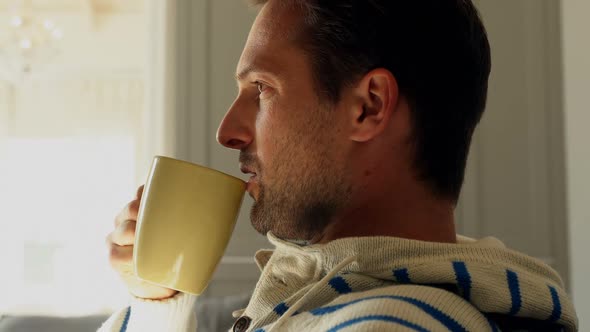Man having cup of coffee at home 4k