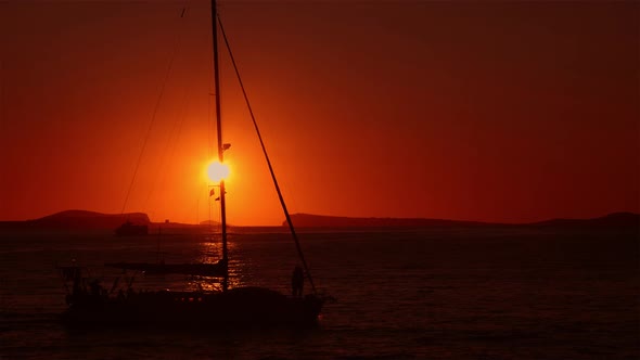 Sailing Boats Going Past Sunset in Ibiza 