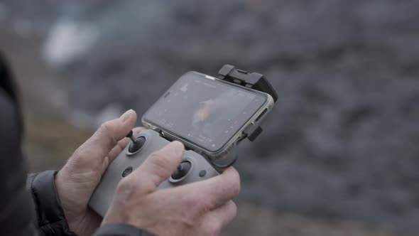 Drone Control Held By Photographer With Screen Showing Lava