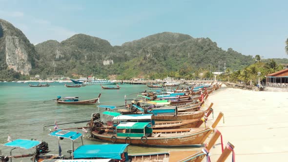 Group of Long-tail boats moored along the shore in Tonsai Bay, Ko Phi Phi Island Paradise, Thailand