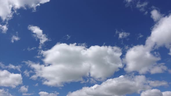 Timelapse of white clouds, 4k. Beautiful cloud are moving in sunshine in the blue sky