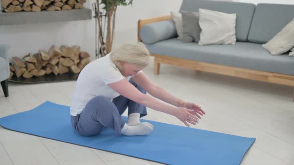 Old Woman Doing Stretches on Yoga Mat at Home