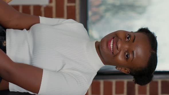 Vertical Video Portrait of Creative Woman Sitting in Front of Canvas with Drawing alt