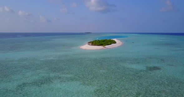 Beautiful flying tourism shot of a white sand paradise beach and aqua blue water background in hi res