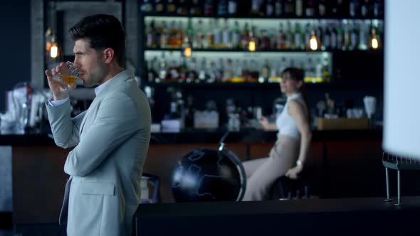 Businessman Drinking Scotch at Restaurant