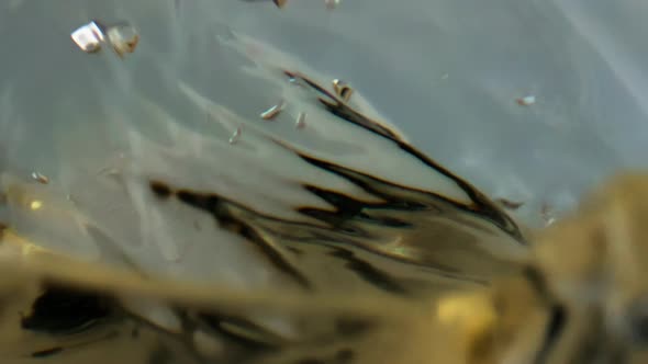 Closeup Wine Droplet Splashing in Goblet