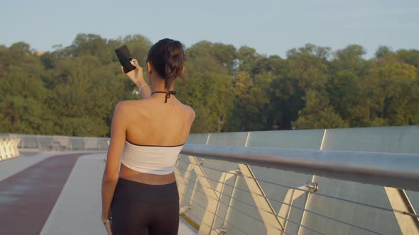 Sporty Fit Woman Taking Selfie on Phone at Sunrise