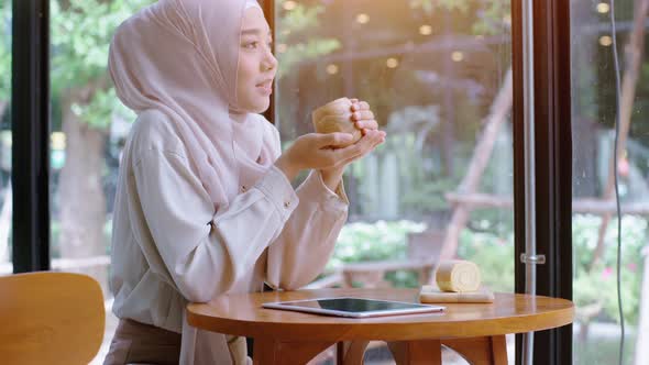 Young Asian Muslim Women Enjoying A Relaxing Moment in the Coffeeshop 06