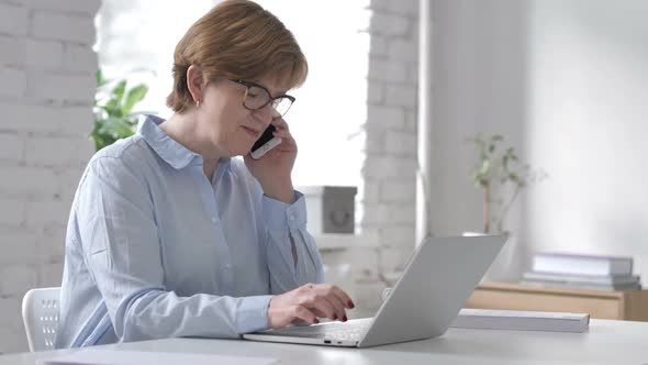 Working Old Woman Talking on Phone