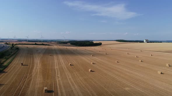 Large Wind Turbines with Blades in Field Aerial View Bright Orange Sunset Blue Sky Wind Park Slow