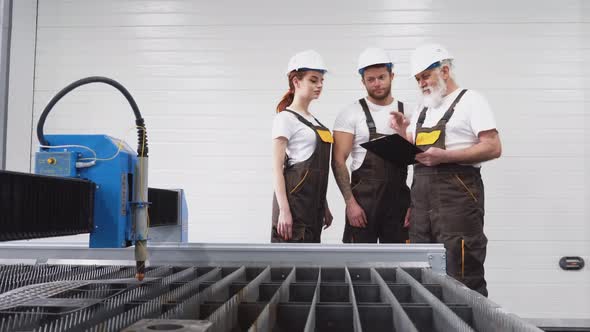 Three Engineers Inspecting Plasma Cutter.