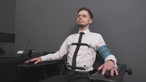 Excited Man with Pulse Indicators Connected To Polygraph