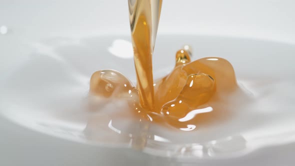 Pouring oil into milk. Slow Motion. alt