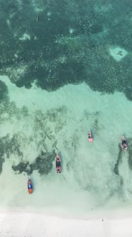 Vertical Video Boats in the Ocean Near the Coast of Zanzibar Tanzania