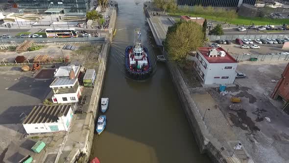 Aerial scene with drones. Boat leaving the city. Aerial camera from the front of the ship. Puerto Ma