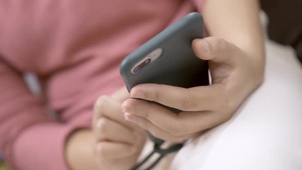 Close up focus on woman hands using a smartphone to social media. Technological addiction concept.